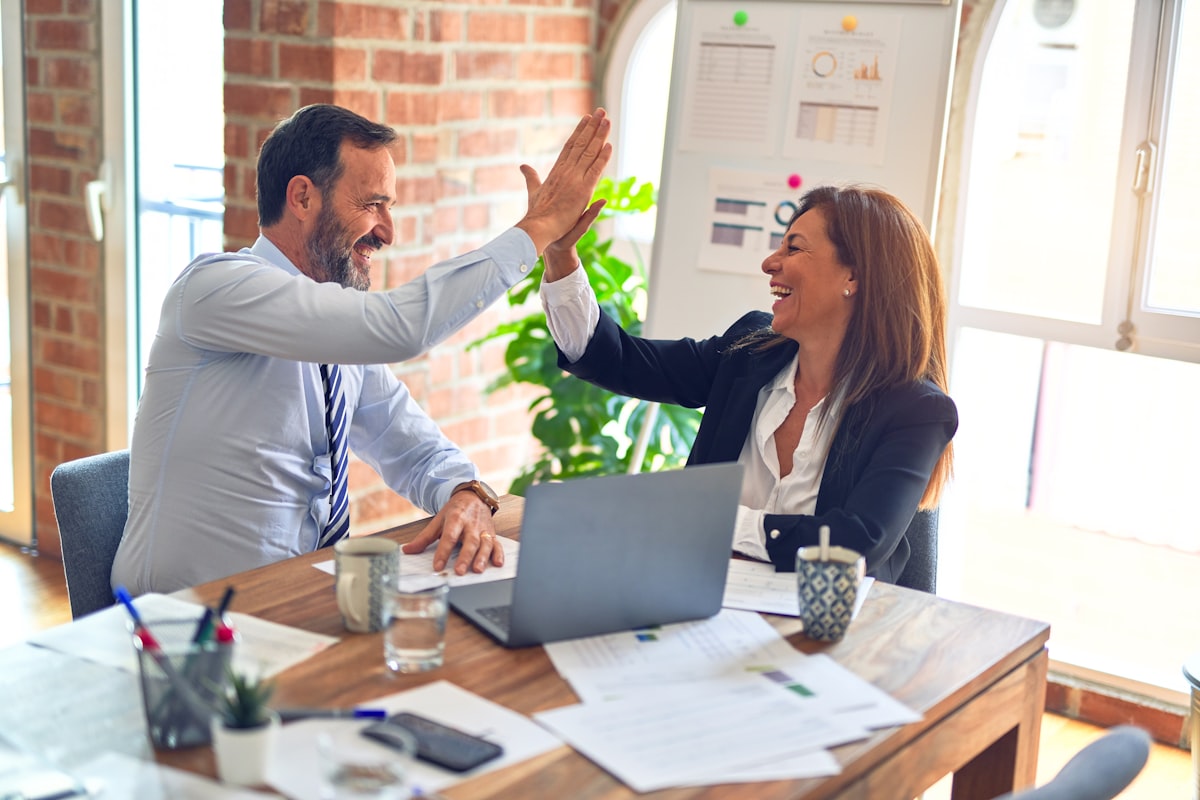 Two professionals shaking hands in a bright meeting
