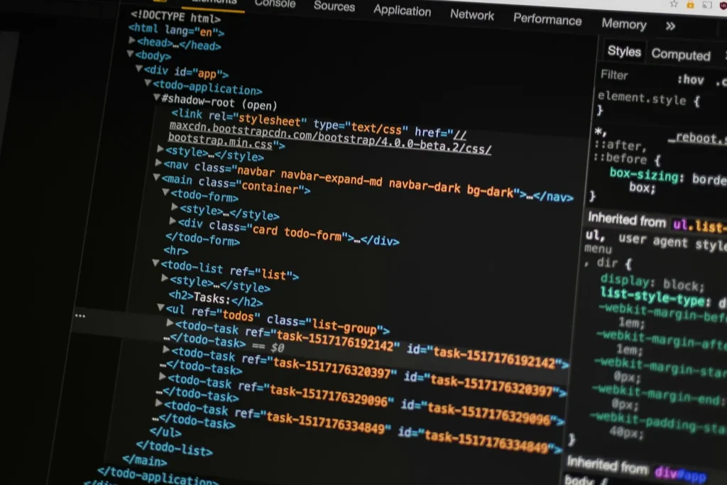 A laptop screen glowing with code at night